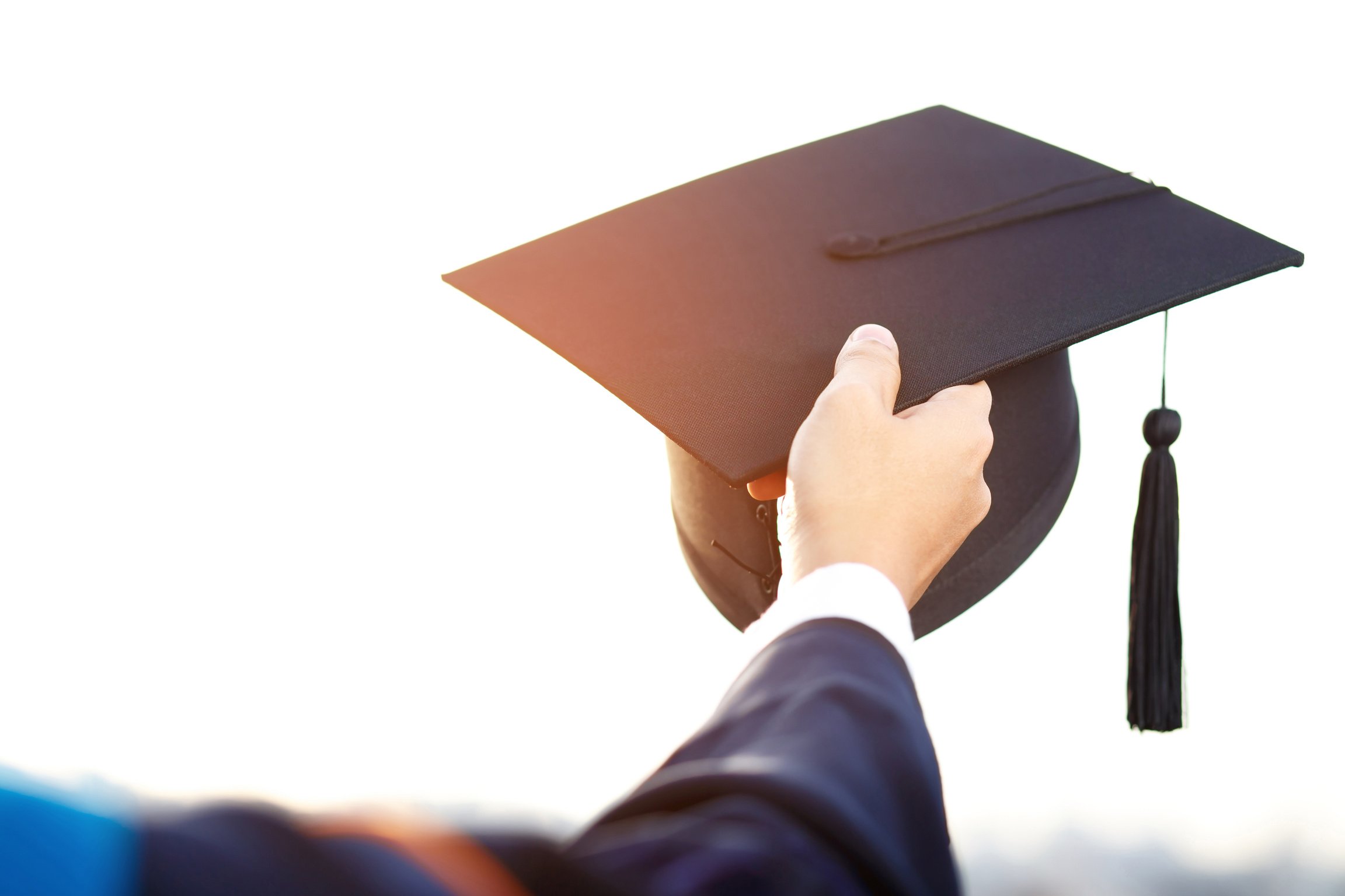 Hand Holding Graduation Cap